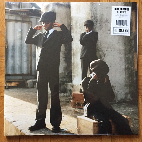 Image of Front Cover of 2xLP - NEW/NEW - EZRA COLLECTIVE, Here Because of Hope (Partisan Records; PTSN3069-5, UK 2026, Gatefold, Inner, Translucent White), , Ezra Collective's Here Because Of Hope is the most ambitious and personal record of their career - conceived as a body of work split into three spiritual and geographical movements, the album traces the movement of Black people across continents and decades, from the music of Africa to the rhythms of the Caribbean, and home to the streets of London. Fo
