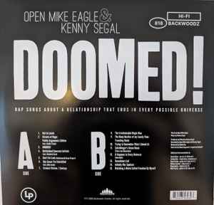 Image of Back Cover of LP - NEW/NEW - OPEN MIKE EAGLE & KENNY SEGAL, Doomed! (Backwoodz Studioz / Rhymesayers; BWZ818LP, UK 2026), , It s five years in a blender. It s every troublesome misunderstanding of a half-decade relationship distorted and stretched into an absurdist black comedy mini-series on wax. It s the sound of every fight we ever had, playing simultaneously. It s several consecutive voice notes that you did not listen to, and instead read the transcription. It s fifteen songs from iconoclastic