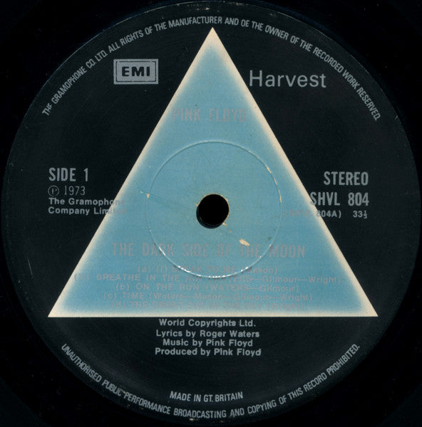 Image of Label Cover of LP - G/G+ - PINK FLOYD, The Dark Side Of The Moon (Harvest Black/Solid Blue; SHVL 804, UK 1973, Gatefold, Black Inner, 2 Posters, 1 Sticker, A2/ B2 Matrix, Grammophone Labels at 10 o'clock), Record Is Close To VG, Surface Noise And Pops. Sleeve Has Split Seems, Edge Wear And Ring Wear., Very first pressing with SOLID BLUE TRIANGLE LABELS. Grammophone Company Limited at 10 o'clock. EMI Boxed logo. Standard Black Sleeve. Gatefold with one side opening. Comes with NO Posters OR Stickers