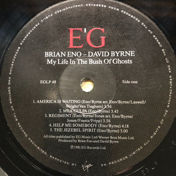 Image of Label Cover of LP - G/VG - BRIAN ENO AND DAVID BYRNE, My Life in the Bush of Ghosts (EG; EGLP48, UK 1980s Reissue, No "Qu'ran"), Light hairlines. Sleeve is tatty with heavy edgewear and creases. Top right corner hanging off., - 3926306E