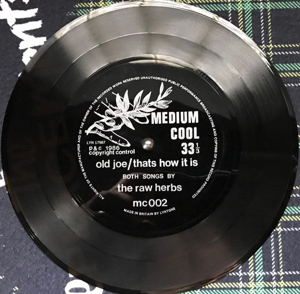 Image of Label Cover of 4624085E: 7" Flexidisc - THE RAW HERBS, Old Joe (Medium Cool; MC002, UK 1986, Pasted Prints On Plain Sleeve, One Sided Flexidisc)   VG+/VG+