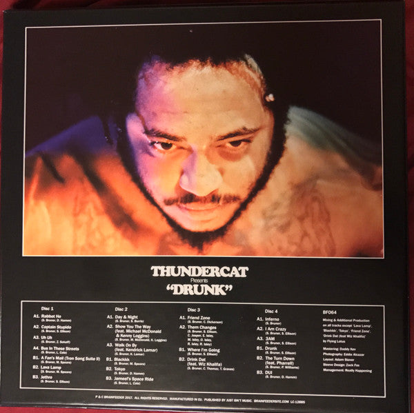 Image of Back Cover of 4x10" LP - NEW/NEW - THUNDERCAT, Drunk (Brainfeeder; BF064 , UK 2017, Box Set, Red Vinyl), , If you move in certain areas of music (the LA Brainfeeder / cosmic jazz axis and surrounds), you will appreciate Thundercat as a god-like figure. The man plays electric bass like nobody s business, but he is also a mighty songwriter, and Drunk is his own record. It features an amazing cast of collaborators (Kendrick Lamar! Kamasi Washington! Michael McDonald!), and is presented on one CD or fo