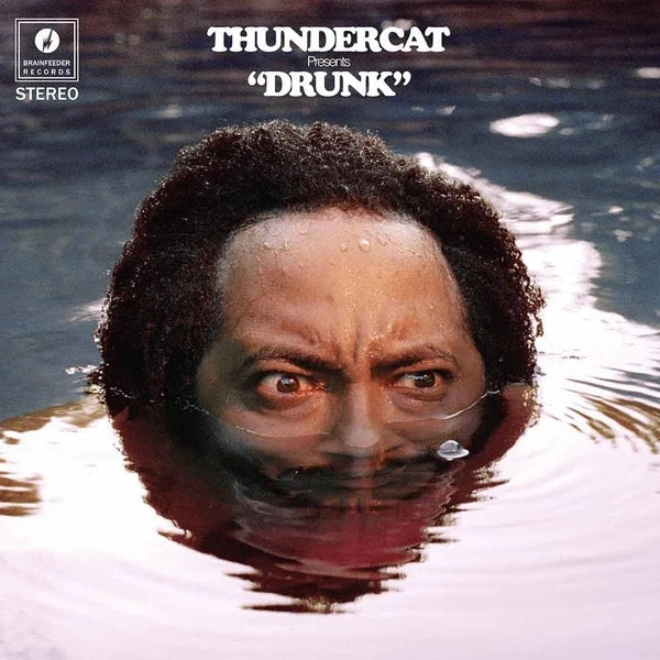 Image of Front Cover of 4x10" LP - NEW/NEW - THUNDERCAT, Drunk (Brainfeeder; BF064 , UK 2017, Box Set, Red Vinyl), , If you move in certain areas of music (the LA Brainfeeder / cosmic jazz axis and surrounds), you will appreciate Thundercat as a god-like figure. The man plays electric bass like nobody s business, but he is also a mighty songwriter, and Drunk is his own record. It features an amazing cast of collaborators (Kendrick Lamar! Kamasi Washington! Michael McDonald!), and is presented on one CD or f