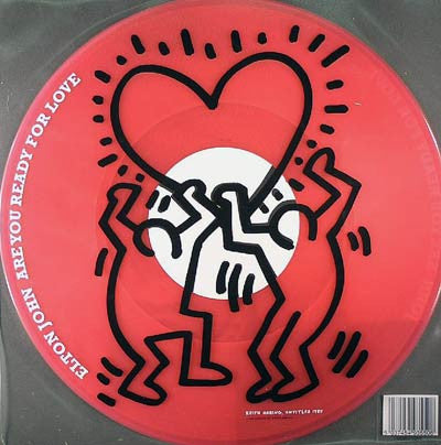 Image of Front Cover of 12" - VG+/VG+ - ELTON  JOHN, Are You Ready For Love (Southern Fried Records ; ECB50LOVE , UK 2003, Printed Clear Plastic Sleeve, Limited to 5000 copies on Transparent Pink Vinyl. The plastic sleeve features artwork by Keith Haring.), Light fogging,  - 1546262S