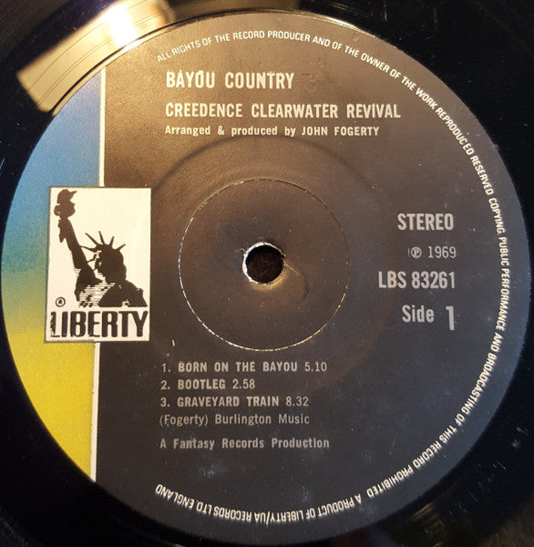 Image of Label Cover of LP - VG/G+ - CREEDENCE CLEARWATER REVIVAL, Bayou Country (Liberty Black With Blue/Yellow Labels; LBS 83261, UK 1970s Reissue, Laminated Sleeve), Light marks only, Laminate lift at sleeve spine,  - 3716375C