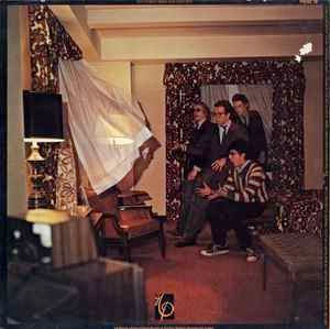 Image of Back Cover of LP - VG+/VG+ - ELVIS COSTELLO, This Year's Model (Imp Records; FIEND 18, UK 1984 Reissue, Inner & Advert Insert, Misprinted cover without deliberate error.), A couple of light hairlines.,  - 2526048E