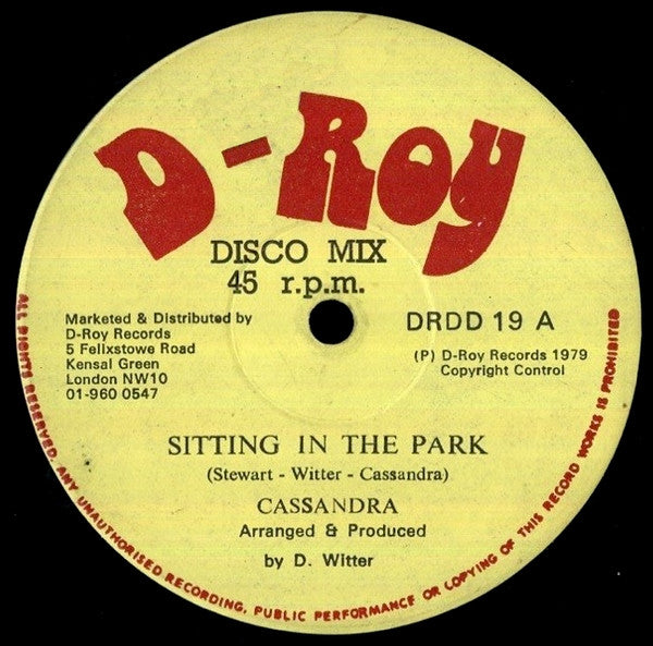 Image of Label Cover of 12" - G+/G+ - CASSANDRA, Sitting In The Park / Hyde Park Dub (D-Roy Records; DRDD 19, UK 1979, Company Sleeve), Marks on disc. Plays well. Tape on cover.,  - 1626112E