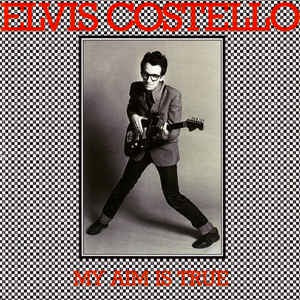 Image of Front Cover of LP - VG/VG+ - ELVIS COSTELLO, My Aim Is True (Stiff; SEEZ 3, UK 1977, Non-Laminated, Yellow Back Cover), Mild fading along spine. ,  - 2426228E