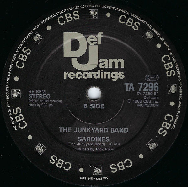 Image of Label Cover of 12" - VG/VG - THE  JUNKYARD BAND, The Word / Sardines (Def Jam Recordings; TA 7296, UK 1986, Stickered Company Sleeve), light marks only. original stickered sleeve,  - 3446031S