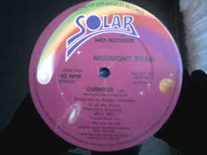 Image of Front Cover of 5114552C: 12" - MIDNIGHT STAR, Curious (Solar; MCAT 961, MCA Records    MCAT 961, UK 1985, Die Cut Company Sleeve) Solid VG across the board.  VG/VG