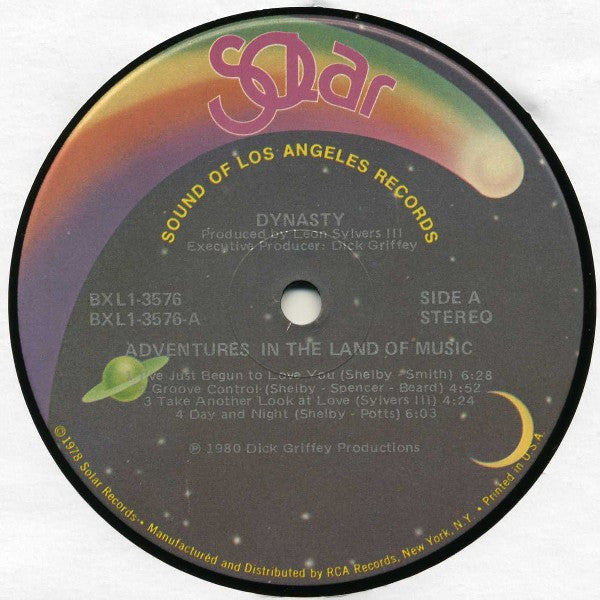 Image of Label Cover of 5114371C: LP - DYNASTY, Adventures In The Land Of Music (Solar; BXL1-3576, US 1980, Picture Sleeve, Inner) Edge of record fogged on B-side. Sleeve has liquid damage and staining; wear and creasing. Inner split and damaged with writing and stains  G+/G