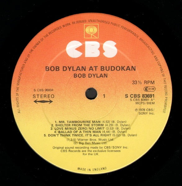 Image of Label Cover of 2xLP - G+/VG - BOB DYLAN, At Budokan (CBS; CBS 96004, UK 1979, Gatefold, Booklet, Poster, Made In England at Bottom of Label), Damp Damage to Sleerve, Poster and Booklet,  - 2226100E