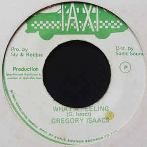 Image of Front Cover of 7" - /VG - GREGORY ISAACS, What A Feeling (Taxi; , Jamaica 1981), Light marks and some light pressing flaws. Label has light damage and staining,  - 2416230C