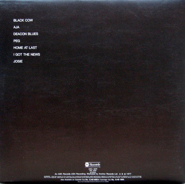 Image of Back Cover of LP - VG/G+ - STEELY DAN, Aja (ABC Orange Rings Label, Round ABC Logo; ABCL5225, UK 1977, Gatefold, NO Inner), Groove wear, hairlines, a few feelable light scratches. Slight discolouration, edge and ring wear, creasing.,  - 2746219S