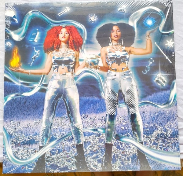 Image of Back Cover of 4044460S: LP - NOVA TWINS, Supernova (Marshall Records ; MAR004LPRT, Worldwide 2022, Silvered Outer Sleeve, Inner, Signed Print, Limited Edition, Clear Vinyl) Strong VG+ with small dent on sleeve  VG+/VG+