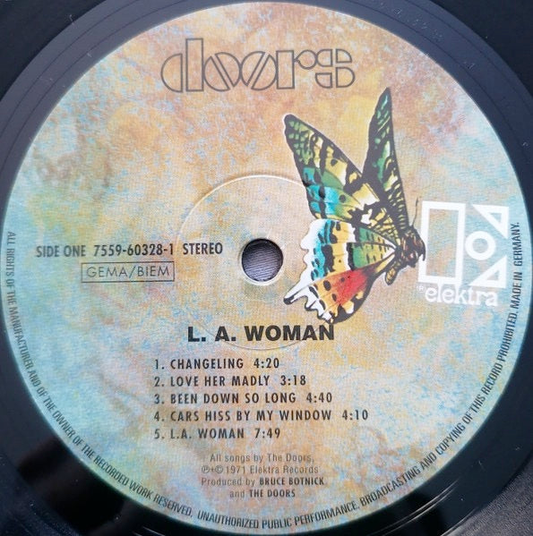 Image of Label Cover of LP - NEW/NEW - THE DOORS, L.A. Woman (Elektra; EKS-75011, Europe 2017 Reissue, 180 Gram Vinyl), , The Doors' sixth studio album, L.A. Woman, features lead singer Jim Morrison, who passed away shortly after its release. The album, heavily influenced by blues, was recorded without producer Paul A. Rothchild and produced by Bruce Botnick. - 2016434C