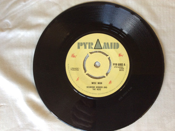 Image of Front Cover of 2424286E: 7" - DESMOND DEKKER & THE ACES / ROLAND ALPHONSO AND THE BEVERLY'S ALL STARS, Wise Man / Middle East (Pyramid; PYR 6003, UK 1967, 4-Prong Centre) Covered in marks, plays better than it looks. No centre piece, WOL.  /G