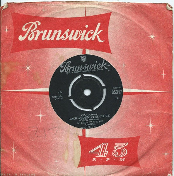 Image of Front Cover of 2514158C: 7" - BILL HALEY AND HIS COMETS, (We're Gonna) Rock Around The Clock (Brunswick Silver/Black; 05317, UK 1960s Reissue, Company Sleeve, 4 Prong Centre. Copyright Control, K/T) Date stamped and cat. no. written on (different to Discogs) sleeve.  VG/VG+