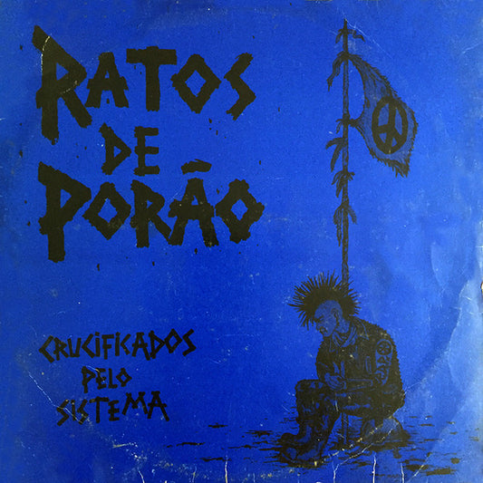 Image of Front Cover of 2744118S: LP - RATOS DE POR O, Crucificados Pelo Sistema (Punk Rock Discos; PR-004, Brazil 1984, Inner & Insert, Blue Cover) Audible Surface Noise Inbetween Tracks. Sleeve Has Light Edge And Ring Wear And A Small Drop Of White Paint.  VG/VG