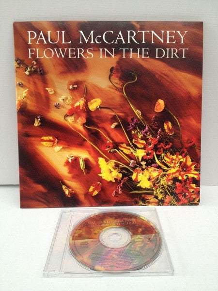 Image of Front Cover of 3355021S: CD - PAUL MCCARTNEY, Flowers In The Dirt (Parlophone; CDP 7 91653 2, UK 1989, Standard UK CD but housed in a 10" gatefold sleeve, containing a 4 page stapled A4 career biography from parlophone and a 10 page stapled A4 description of the album tracks from Paul. All on special watermarked textured paper. Also includes 3 promotional photographs.) CD has light scracthes, rest of media and sleeve in great condition  VG+/G+