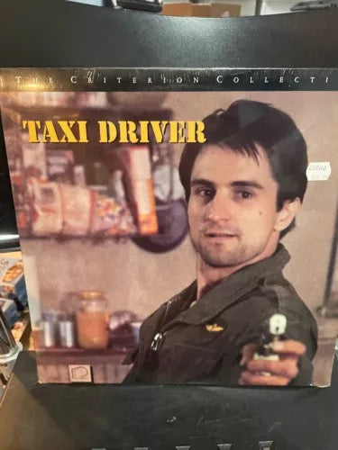 Image of Front Cover of Laserdisc - M/M - MARTIN SCORCESE, ROBERT DE NIRO, Taxi Driver (The Crtiterion collection ; 109A, US 1990), Sealed, The Taxi Driver Criterion Collection laserdisc is a vintage, out-of-print release from 1990, notable for being one of the first home video releases to feature director Martin Scorsese's audio commentary. - 4125009E