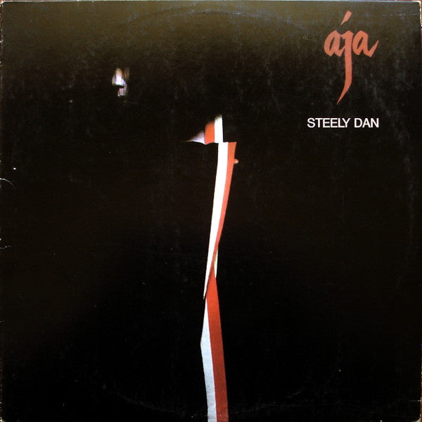 Image of Front Cover of 4625242E: 7" - STEELY DAN, Aja (ABC Records; AB 1006, US 1977, Insert, Alternate Text Layout on Labels: "(P) ABC Records, Inc." in One Line) Strong G+ all around. Dishing to disc. Scuffs, mottling and hairlines. Ring and edge wear, large corner crease.   G+/G+