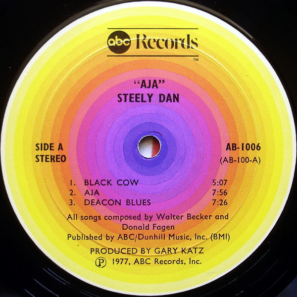 Image of Label Cover of 4625242E: 7" - STEELY DAN, Aja (ABC Records; AB 1006, US 1977, Insert, Alternate Text Layout on Labels: "(P) ABC Records, Inc." in One Line) Strong G+ all around. Dishing to disc. Scuffs, mottling and hairlines. Ring and edge wear, large corner crease.   G+/G+