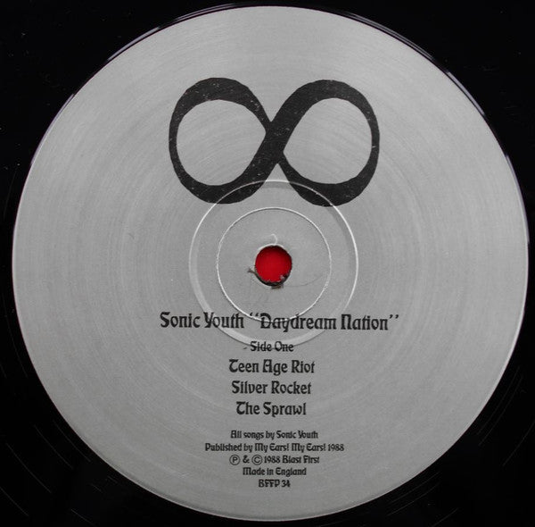 Image of Label Cover of 0526366E: LP - SONIC YOUTH, Daydream Nation (Blast First; BFFP 34, UK 1988, Gatefold, 2 White Inners, No Poster, Early versions of 1st pressing have 2 White inners, not printed inners.) Original issue with 2 white inners (printed inners came later). Disc 1 is VG with some light hairlines. Disc 2 is VG+. Sticker removal area on sleeve where gloss has been removed with sticker.  VG/VG
