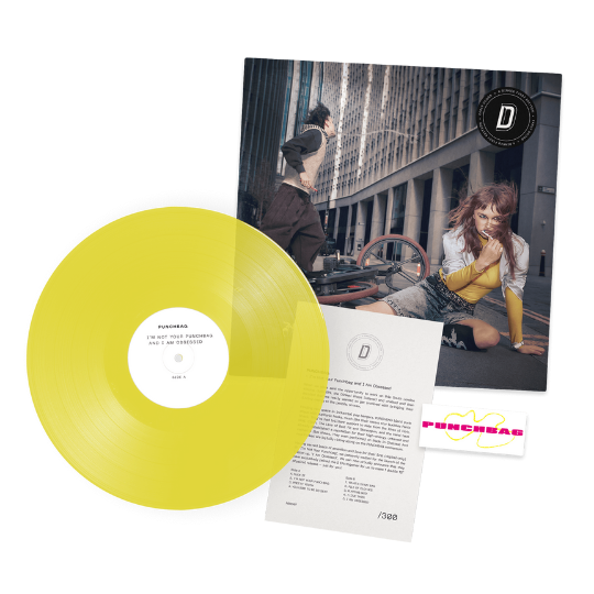 Image of Front Cover of LP - NEW/NEW - PUNCHBAG, I Am Obsessed / I Am Not Your Punchbag - Dinked Edition (Mute; NERD07 , UK 2026, Signed and Numbered A5 Dinked Insert, Temporary Tattoo, Transparent Yellow Vinyl Numbered Limited Edition of 400, Dinked Early Doors Edition ED07), ,  - 1536240E