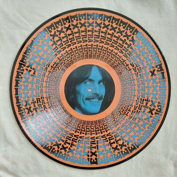 Image of Back Cover of LP - NEW/NEW - GEORGE HARRISON, Extra Texture (Dark Horse Records; 964206961, UK 2026, Numbered Limited Edition Zoetrope Vinyl), , Continuation of the RSD exclusive series reissuing George Harrison's full studio album catalog on limited, numbered Zoetrope vinyl.  In late 1974, George returned to California to record his next album, the soul-tinged Extra Texture (Read All About It.)   Leon Russell played piano on  Tired of Midnight Blue,   and for some of the sessions, Harrison was joi