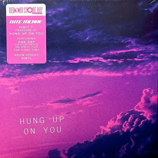 Image of Front Cover of 7" - NEW/NEW - TATE MCRAE, Hung Up On You / One Day (Live From Youtube NYC - February 27, 2020) (Nettwerk; 333691, UK 2026, Picture Sleeve, Inner, Neon Violet Vinyl), , For the first time ever, Tate McRae s  Hung Up On You  arrives on 7" vinyl paired with a special live recording of her breakout single  One Day,  captured at YouTube Space NYC in 2020.From her early days as a So You Think You Can Dance finalist to becoming one of the defining voices of modern pop, the Canadian singer