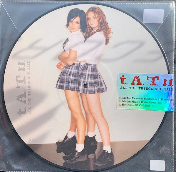 Image of Front Cover of 12" - NEW/NEW - T.A.T.U, All The Things She Said (UMR/Polydor; 8853659, Europe 2026, Limited Edition 12" Picture Disc), , "All The Things She Said  is experiencing a major resurgence following its sync in the HBO Max series Heated Rivalry, which became a viral breakout upon its late-November release. Nearly two months post-sync, the track continues to perform 61% above its streaming baseline and has entered both the Spotify Global and U.S. Top Songs charts weekly and daily for the fi