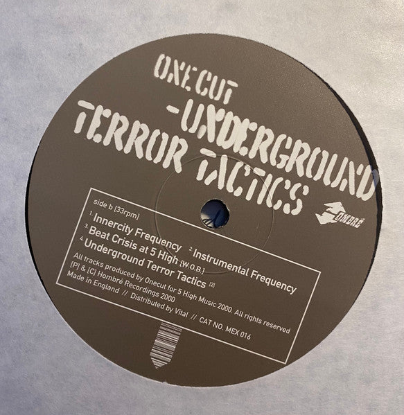 Image of Label Cover of 12" - G+/VG+ - ONE CUT, Underground Terror Tactics EP (Hombr ; MEX 016, UK 2000, Cardboard sleeve), Light marks on disc. Light wear to sleeve - Light ringwear, small tear on bottom, small burn mark on spine. Light stain on sleeve - Banksy image itself in great condition., A1 - Serial OneA2 - Serial TwoA3 - Flesh EatersA4 - Underground Terror TacticsRap [Featuring]   RetnaB1 - Innercity FrequencyB2 - Instrumental FrequencyB3 - Beat Crisis At 5 High (W.O.B.)B4 - Underground Ter