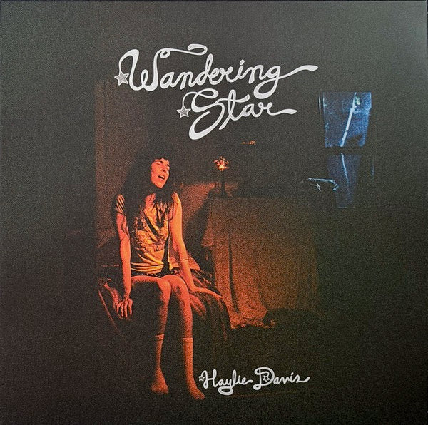 Image of Front Cover of LP - NEW/NEW - HAYLIE DAVIS, Wandering Star (Fire Records; FIRELP815, US 2026, Inner, Black Vinyl), , Los Angeles based singer-songwriter Haylie Davis presents Wandering Star, a coming-of-age debut that unfolds like a Townes Van Zandt tale set in a deserted diner off a re-routed interchange: intimate, cinematic and quietly fearless. - 2356144S
