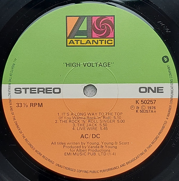 Image of Label Cover of LP - G+/G+ - AC/DC, High Voltage (Atlantic Green & Orange With W In Rim Text; K 50257, UK 1970s Reissue, Arun/Strawberry Matrices), PLays fine throughout but has some long light marks and a couple of circular marks, Sleeve intact but heavy spine wear. ,  - 1916188C