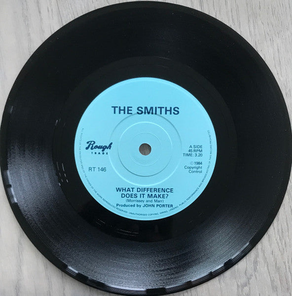 Image of Label Cover of 7" - VG/VG - THE SMITHS, What Difference Does It Make? (Rough Trade; RT 146, UK 1984, Morrissey Cover, Cursive Rough Trade Logo on Label, Solid Centre), Edge and ring wear. Disc essentially VG+ with one unfeelable hairline.,  - 2056063S