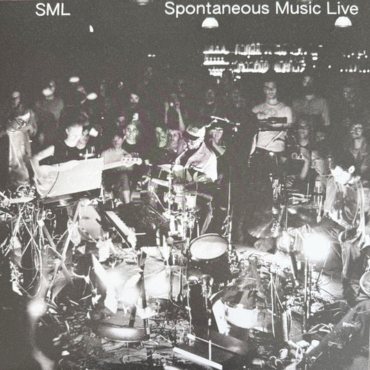 Image of Front Cover of LP - NEW/NEW - SML, Spontaneous Music Live (International Anthem; IARC112LP, Europe 2026), , Spontaneous Music Live contains two side-length pieces of unedited improvisation, recorded live at Los Angeles venue Zebulon during SML's December 2025 three-night residency, just weeks after the release of the band's second album HOW YOU BEEN. It was recorded and mixed live to stereo tape by Bryce Gonzales (the same engineer/wizard known for his gorgeous live captures/mixes of Jeff Parker's 