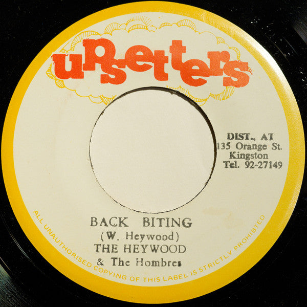 Image of Front Cover of 7" - /G+ - THE HEYWOOD & THE HOMBRES, Back Biting (Upsetters; none, Jamaica 1976), Record marked and plays through with light crackle and pops in places. A-side label has writing in marker pen and biro; B-side label off-centre,  - 2316494C