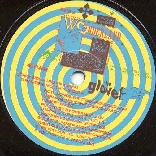 Image of Label Cover of 7" - VG/VG+ - THE GLOVE, Like An Animal / Mouth To Mouth (Wonderland Paper Labels; SHE 3, UK 1983, Picture Sleeve With Hole Drilled, Robert Smith, Steven Severin), Corner Bumps,  - 2326204E