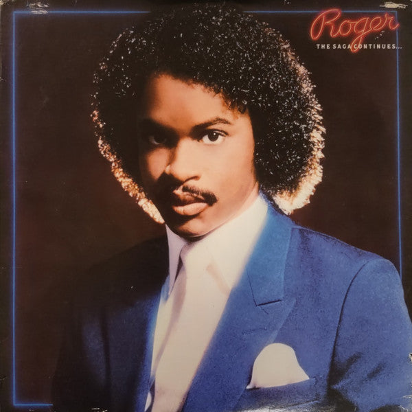 Image of Front Cover of LP - VG/VG - ROGER, The Saga Continues... (Warner Bros. Records; 23975-1, US 1984, Inner), Sleeve shrink-wrapped with hype sticker on plastic; wear and small rips along opening. Inner split and taped at edges,  - 2416506C