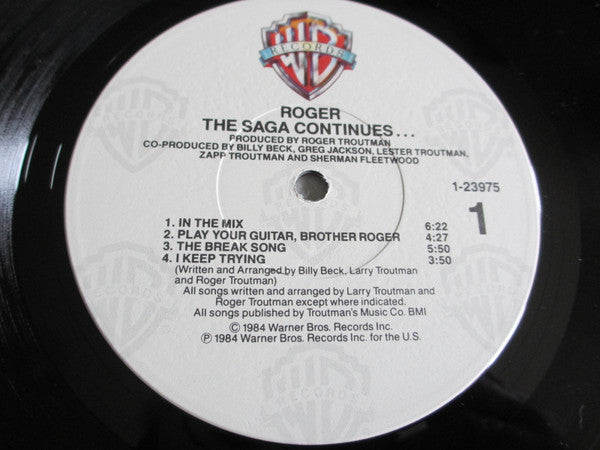 Image of Label Cover of LP - VG/VG - ROGER, The Saga Continues... (Warner Bros. Records; 23975-1, US 1984, Inner), Sleeve shrink-wrapped with hype sticker on plastic; wear and small rips along opening. Inner split and taped at edges,  - 2416506C
