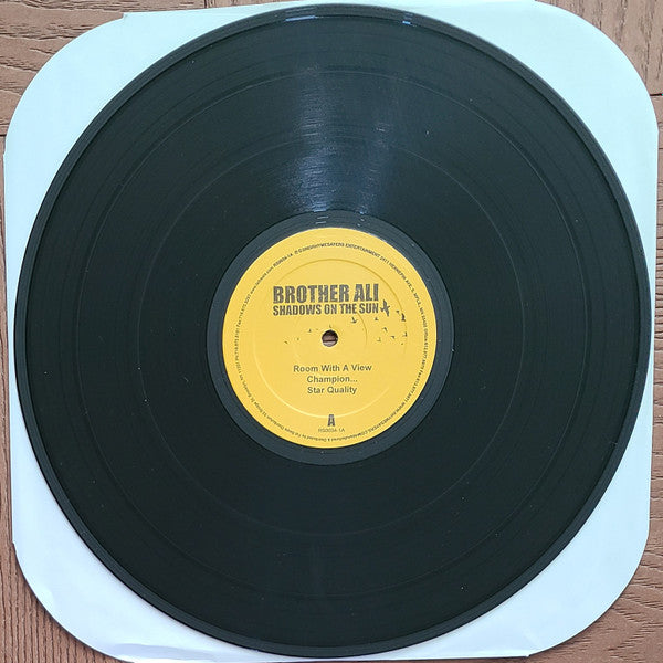 Image of Label Cover of 3xLP - G+/VG - BROTHER ALI, Shadows On The Sun (Rhymesayers Entertainment; RS0034-1, US 2003, Gatefold), Light marks only, sleeve has some wear, and a small tear on the open side.,  - 2526006E