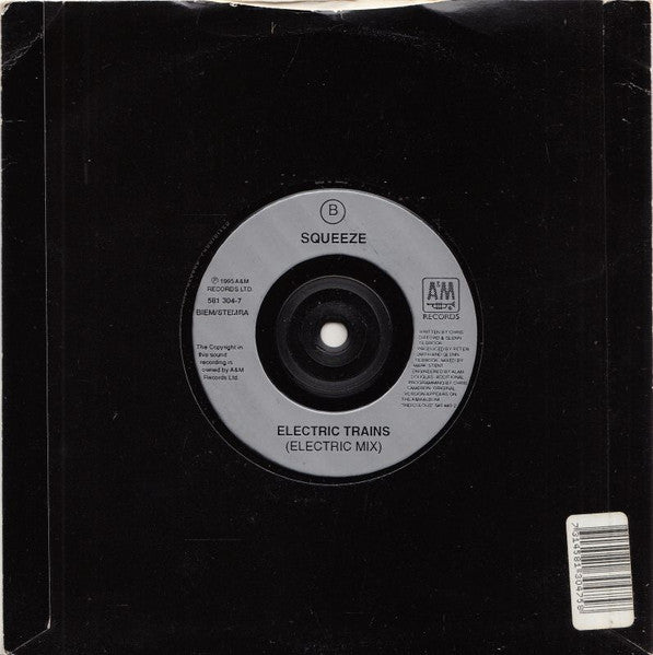 Image of Back Cover of 7" - VG+/VG+ - SQUEEZE, Electric Trains (A&M Records; 581 304-7, UK 1995, Barcode Stickered Plain Black Sleeve), Small promo stickers on label and sleeve, light crease to top.,  - 3016281C