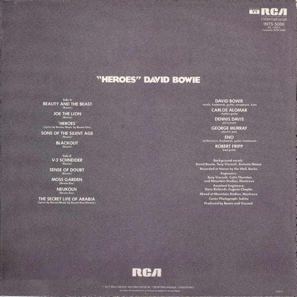 Image of Back Cover of LP - G+/VG - DAVID BOWIE, "Heroes" (RCA International Green International Left Orientated; INTS 5066, UK 1980s Reissue, 3E But No Bilbo Runout Side A, Strawberry Runout Side B), Light marks and some mottling, Small chunk missing at sleeve opening on rear, generally worn. ,  - 3116090C