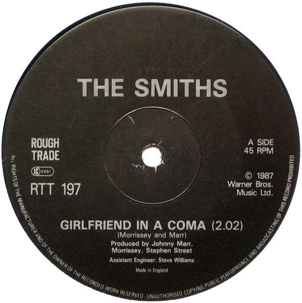 Image of Label Cover of 12" - VG/G+ - THE SMITHS, Girlfriend In A Coma (Rough Trade; RTT 197, UK 1987, Green Tint Sleeve, Black Die Cut Inner, EMI Pressing, Alternate Mastering Source), Mottling and hairlines. Light edge and ring wear, indents to sleeve.,  - 3446201S