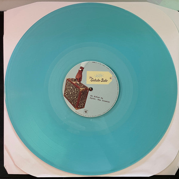 Image of Label Cover of 3xLP - VG+/VG+ - TYLER, THE CREATOR, Call Me If You Get Lost: The Estate Sale (Columbia; 19658814881, Worldwide 2023 Reissue, Embossed Triple Gatefold Sleeve, Booklet, Deluxe Edition, Blue [Geneva] Vinyl), , "Call Me If You Get Lost : The Estate Sale" contains:* The original album (16 songs)* 8 additional unreleased songs* 3 LPs pressed on Geneva blue coloured vinyl* 28 page booklet* Housed in an embossed trifold jacket with Estate Sale stickerTrack D4 is Fishtail, rather than