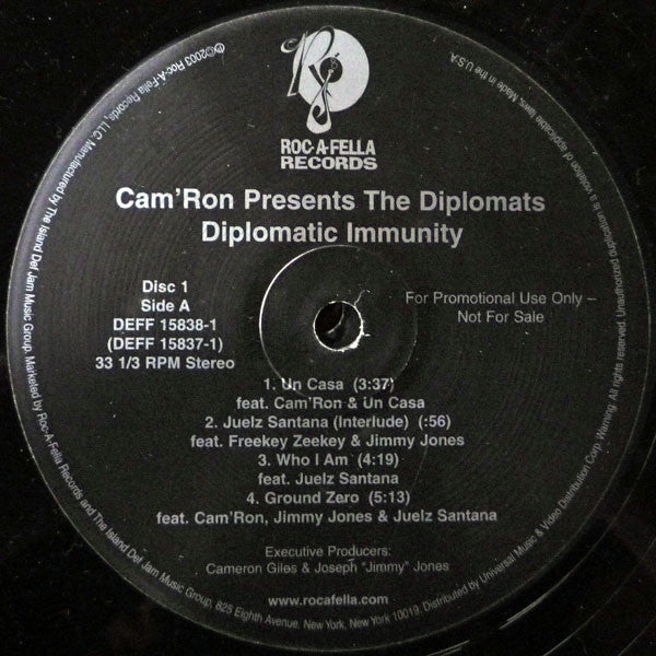 Image of Label Cover of 4xLP - VG/G+ - CAM'RON PRESENTS THE DIPLOMATS, Diplomatic Immunity (Roc-A-Fella Records; DEFF 15837-1, US 2003, Promo, Company Sleeve, Clean versions.), Lots of marks on disc. Plays well above grade. Sticker residue on labels. Ringwear & light creasing on company sleeve., A1 - Un Casa	3:37A2 - Juelz Santana (Interlude)	A3 - Who I Am	4:19A4 - Ground Zero	5:13B1 - Real Ni***s (Interlude)	B2 - Real Ni***s	3:46B3 - Have You Seen Juelz Santana (Interlude)	0:44B4 - More Than Music	4
