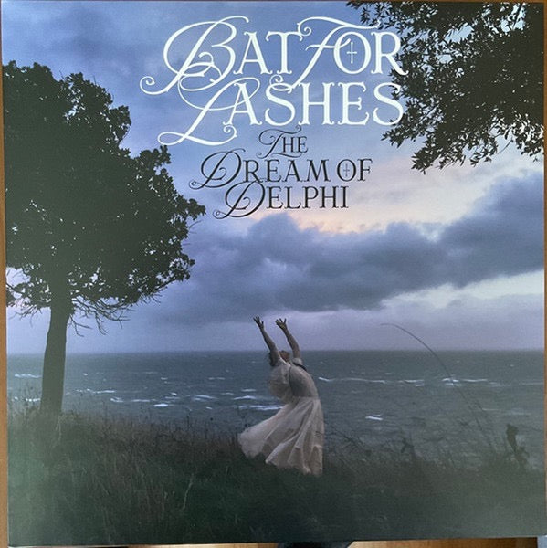 Image of Front Cover of LP - NEW/NEW - BAT FOR LASHES, The Dream Of Delphi (Mercury KX; 6501833, Worldwide 2024, Gatefold, Red Vinyl), , Natasha Khan at her most intimate, letting harp, piano, chamber strings and soft-focus electronics carry songs about early motherhood. It is a gentle, slightly strange record with proper weight to it, moving from nursery-room hush to the bright electronic lift of  Home . Quietly ambitious, beautifully arranged and never overdone. - E