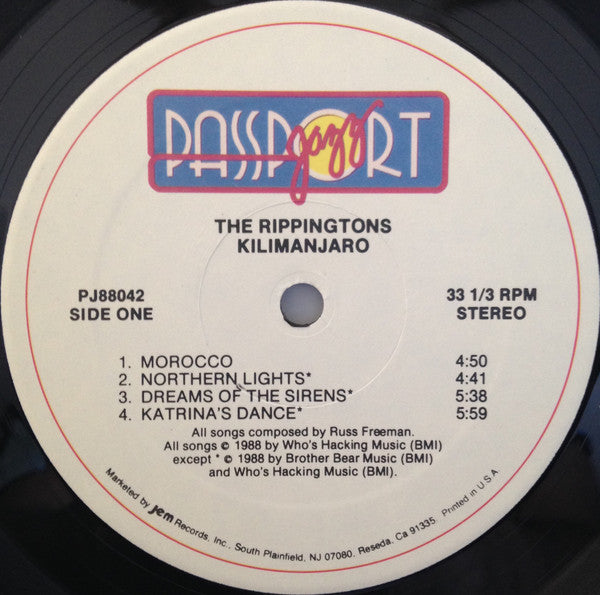 Image of Label Cover of LP - G+/G+ - RIPPINGTONS FEATURING RUSS FREEMAN, Kilimanjaro (Passport Jazz; PJ 88042, US 1988), Two notable marks on B-side. Sleeve has wear and splits at edges / corners; an old sticker on front and staining,  - 3816334C