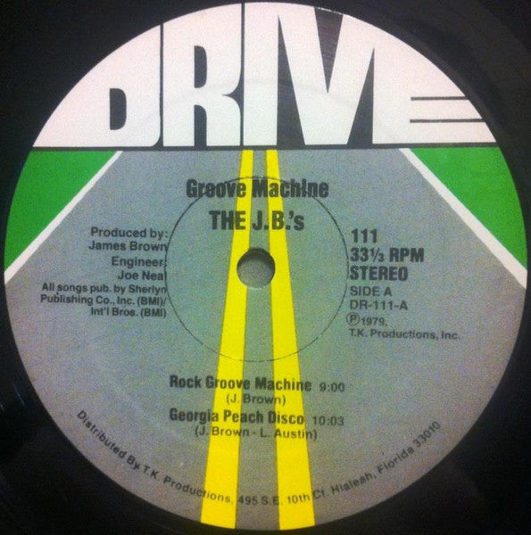 Image of Label Cover of LP - G+/VG+ - THE J.B.'S, Groove Machine (Drive; 111, US 1979), Sleeve has edgewear and a tear top left that removes some of the cover image (band logo).,  - 4126064E